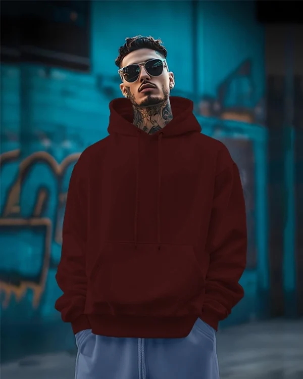 Back_Printed_Maroon_essential_hoodie-FRONT Back Printed Maroon Essential Hoodie with premium cotton fleece fabric, oversized fit, stylish graphic back print, kangaroo pocket, adjustable hood, and ribbed cuffs on a clean white background.