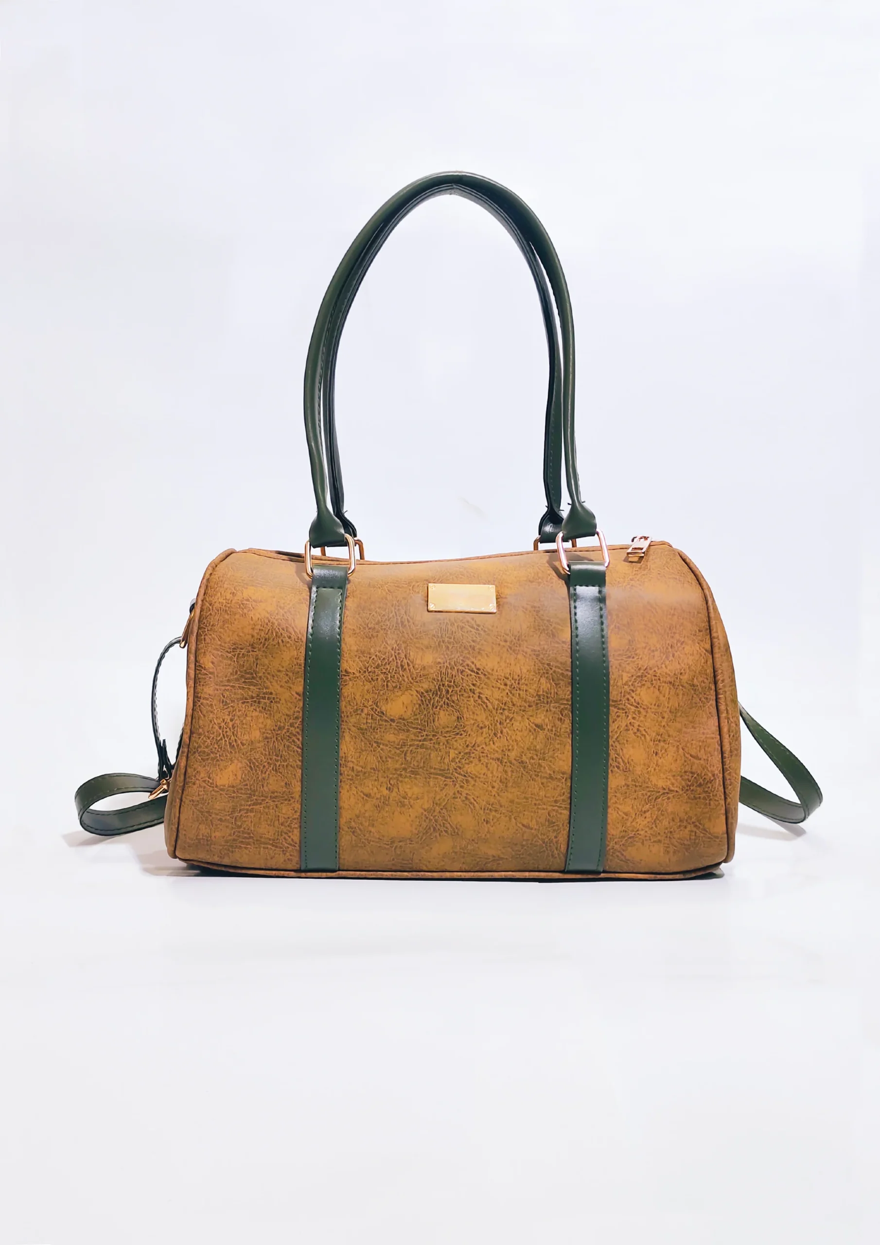 LadiesTravelhandbagincoloryellowishwithgreenstrap Elegant genuine leather women's handbag in brown with premium craftsmanship, spacious compartments, adjustable shoulder strap, and modern stylish design.