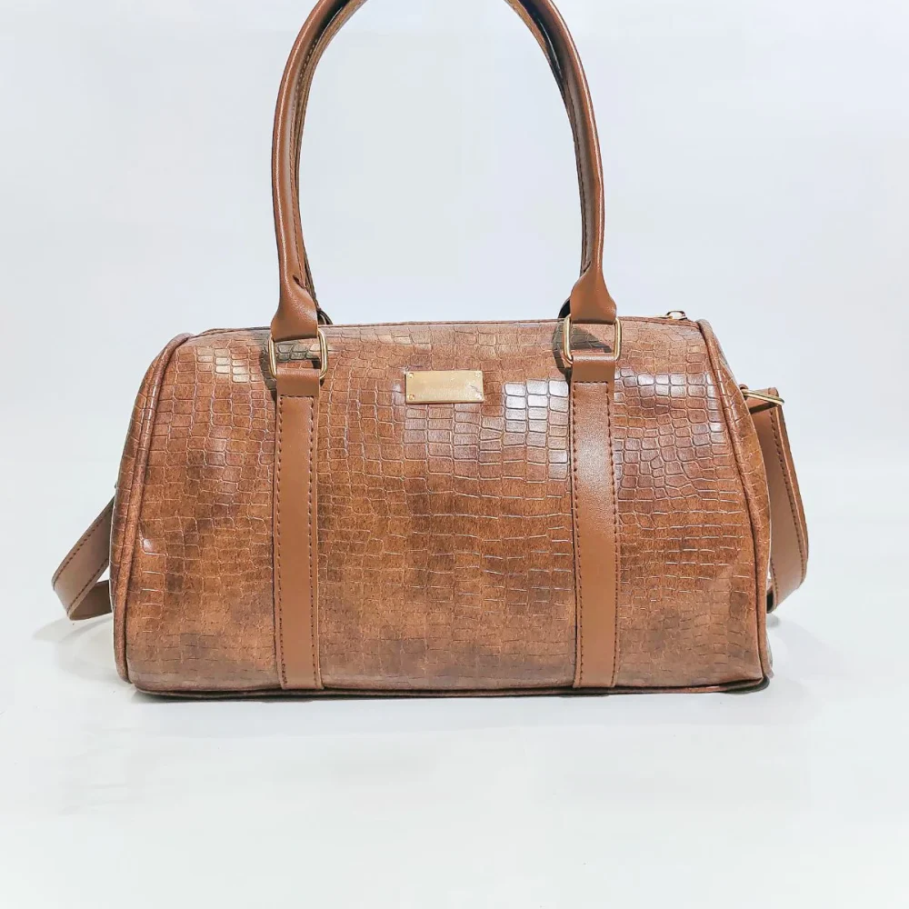 Elegant genuine leather women's handbag in brown with premium craftsmanship, spacious compartments, adjustable shoulder strap, and modern stylish design.Premium Stylish